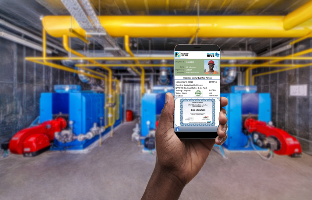 A first person view of a hand holding a phone. On the phone is the holder's certificate of training in electrical safety.